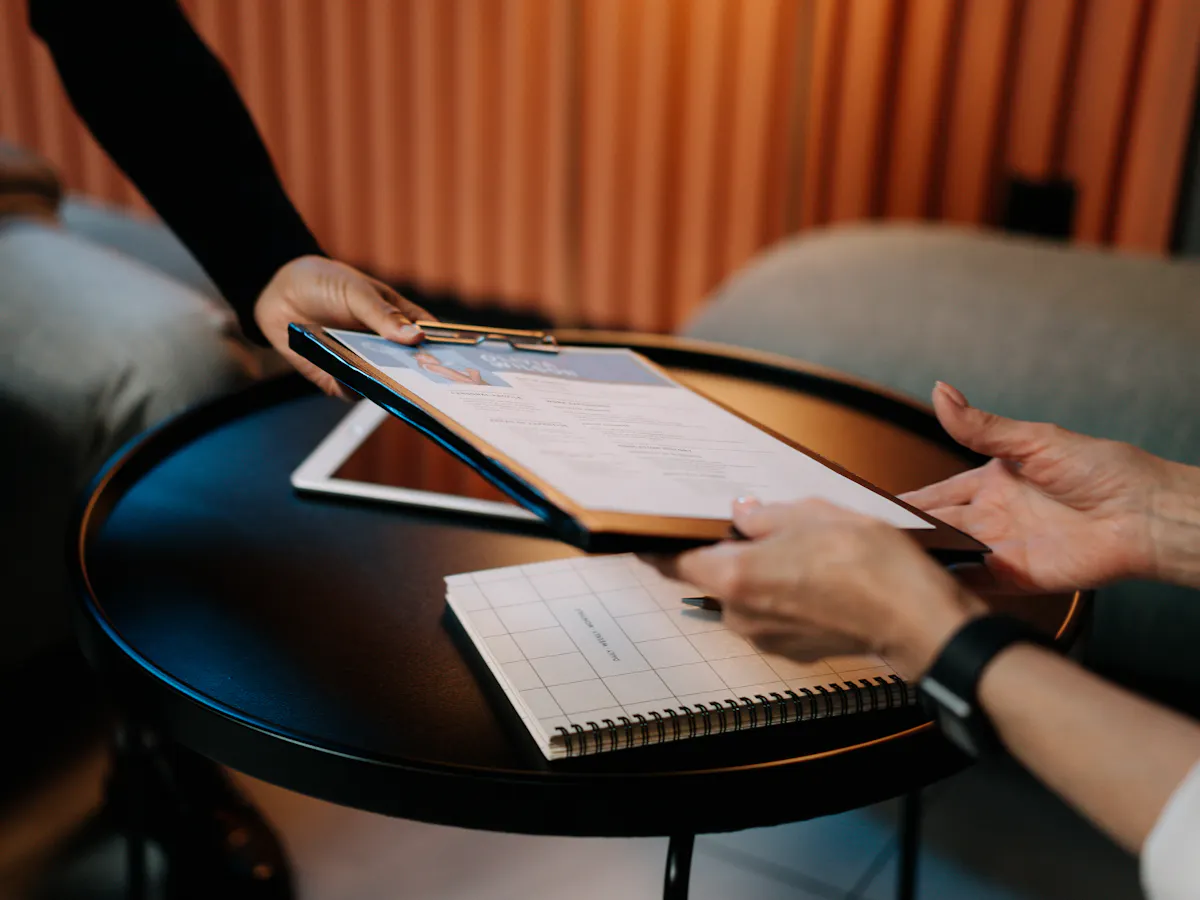 A resume being handed over, symbolizing a career boost potentially gained from completing ESG courses online and obtaining ESG training certification.