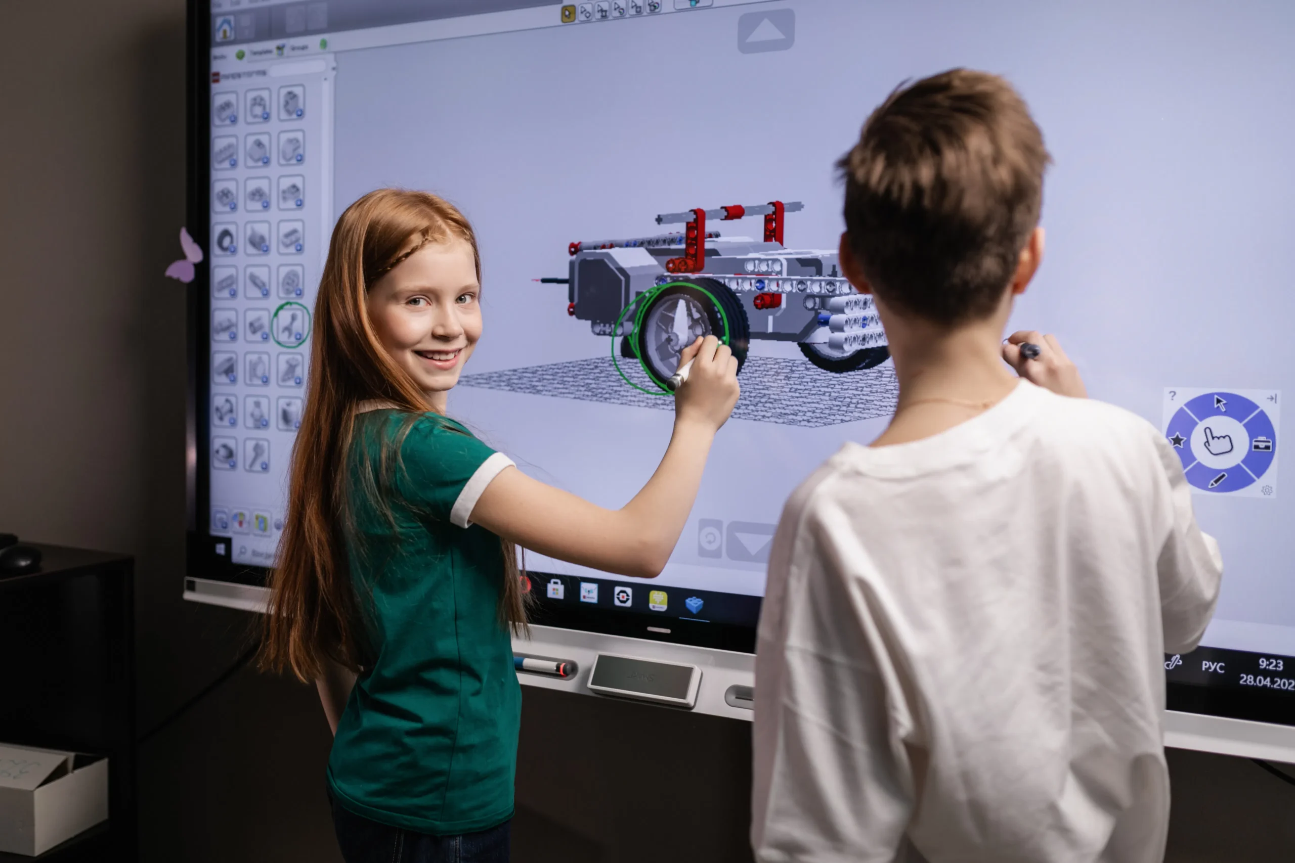 Children working on a project on a smart board, possibly related to learning concepts that align with ESG training and values for a sustainable future.