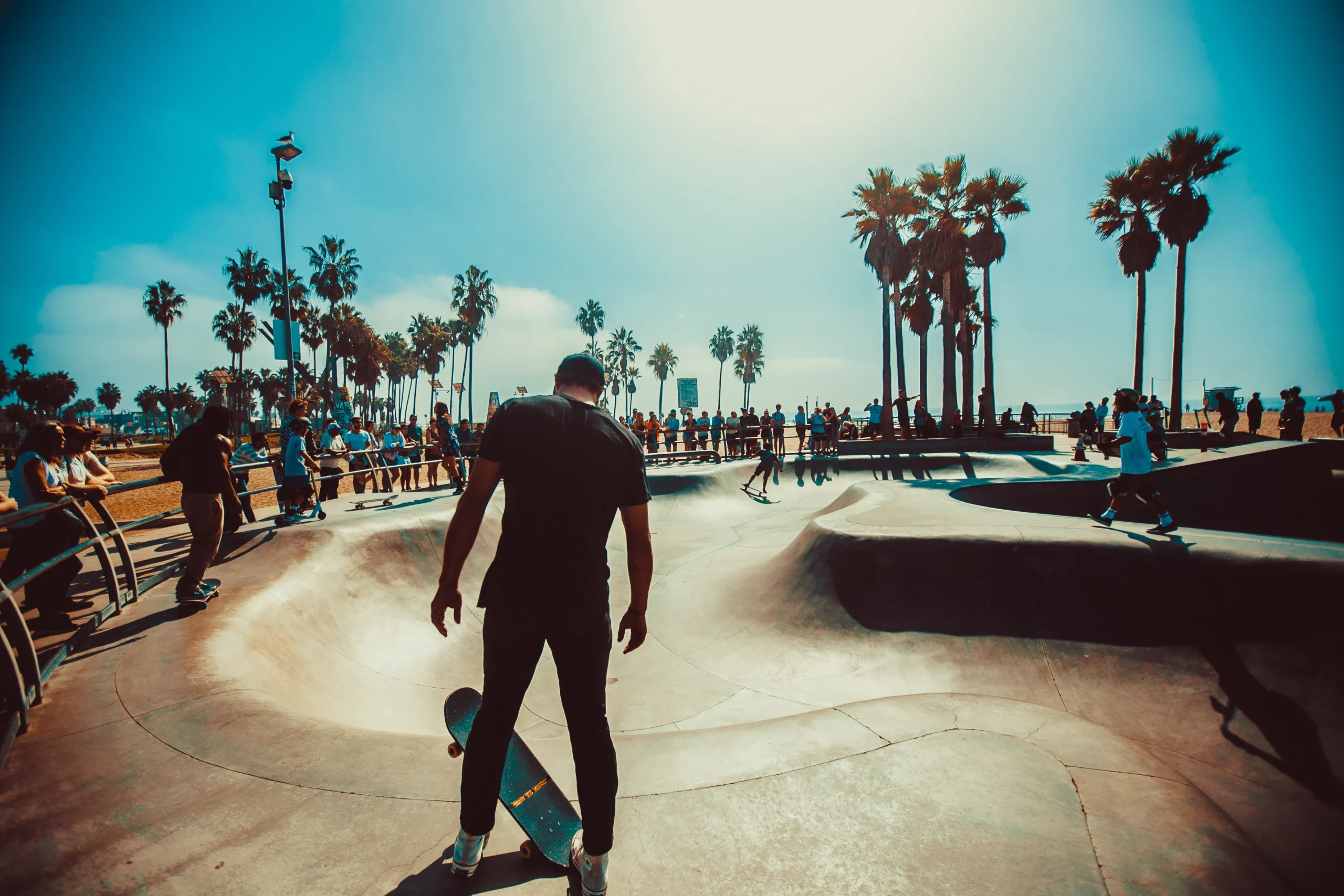 A skateboard park under a sunny sky, with people enjoying the space, illustrating community and social engagement, which ties into the 'S' in ESG, emphasizing the importance of ESG training and courses on ESG for sustainable community development.