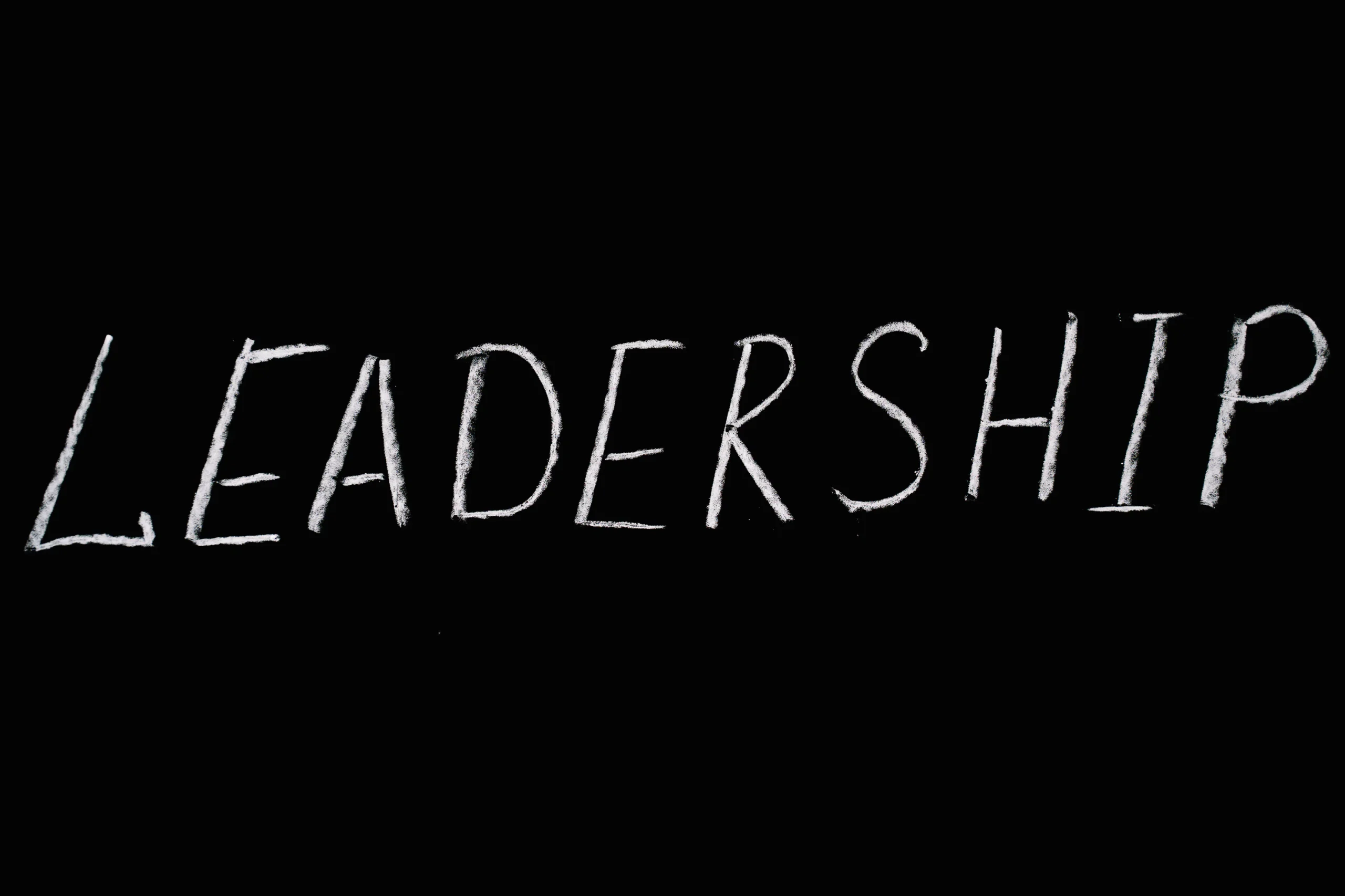 The word LEADERSHIP written in chalk on a black background, highlighting the leadership qualities enhanced through ESG training courses and ESG online courses.